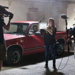 On-set photo of actors and production students with film equipment