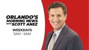 Smiling man in a suit with text: "Orlando's Morning News with Scott Anez, Weekdays 5AM - 9AM" on a red and white background.