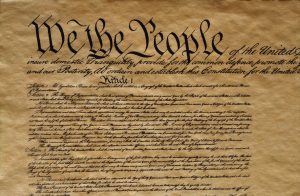 Close-up of the preamble and first article of the U.S. Constitution, featuring the iconic phrase "We the People" in large, elaborate script.