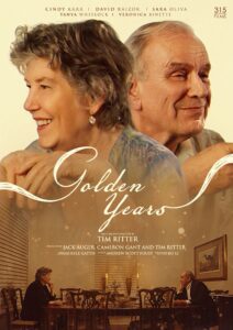 An older woman and man sit across from each other at a dinner table; large portraits of them smiling appear above with the title "Golden Years" and film credits displayed.